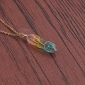 Detailed view of wire-wrapped rainbow crystal column pendant on a golden chain necklace - A-NSN0234 Gold Stainless Steel O-Chain