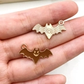 Close-up of golden bat pendants with celestial patterns and smiling face details - Brown Bat
