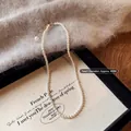 Elegant 4mm white pearl necklace with gold lobster clasp on black canvas tray - 4MM Pearl + Gold Tail Chain / Cream