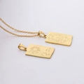Detail of gold Leo zodiac rectangle pendant necklace with engraved lion head and stars - Leo