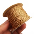 Close-up of 1mm gold-woven cotton thread for DIY jewelry with detailed fiber texture - Coral