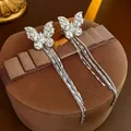 Silver zircon butterfly ear cuff with long chain tassels on a velvet jewelry box - Silver