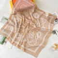 Detail of silk satin square scarf with paisley pattern next to premium packaging box - 70*70cm / Light Khaki