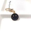 Golden alloy keychain with black enamel smiley face charm and lobster clasp on ceramic tray - Round Face Single Black