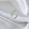 Elegant adjustable silver ring featuring three light green jade beads on a white silk base - Three Nephrite Jade Ring (Platinum Plated)