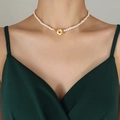 Baroque freshwater pearl necklace with gold flower toggle clasp worn on a model neckline - 35cm / Gold Necklace-35cm