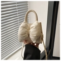 Close-up of off-white crossbody bag featuring a large decorative bow and soft PU texture - Off White