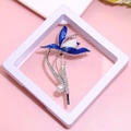 Detail view of blue enamel flower brooch with pearls and rhinestones on a display stand - XZ186-Blue Flower-Boxed