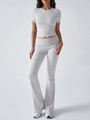 Full body shot of a grey two-piece set featuring short sleeve crop top and flared pants - S / Gray