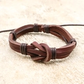 Handmade brown leather wrap bracelet with infinity knot design on a neutral stone background - Brown