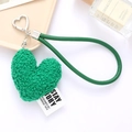 Close-up of a green plush heart keychain with a faux leather strap and metal buckle - Green