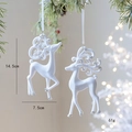 White flocked reindeer Christmas ornaments with silver glitter hanging on pine tree branches - Pair of Reindeer