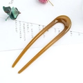 U-shaped brown resin hair pin for minimalist daily hairstyles on a clean white desk - Ginger Yellow