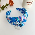Detailed close-up of blue floral print knotted headband with satin fabric texture - Blue Printed Wide Knotted Headband