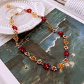 Detail of handmade beaded flower necklace with red petals and golden lobster clasp - Multicolor Flower Beaded Necklace - Gold Accessories