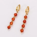 Vintage gold hoop earrings featuring symmetrical orange red beaded tassels - Red