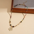 Detail of tiger eye bead necklace featuring a matte gold flower pendant with adjustable chain - Multicolor Flower (WN1769)