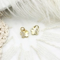 Macro view of gold butterfly charms with cubic zirconia stones for DIY jewelry making - Butterfly