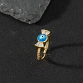 Macro detail of gold-plated evil eye ring with blue enamel and white zircon accents - P-Bowknot Blue Eye