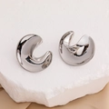 Minimalist silver S925 geometric C-shaped stud earrings on a stone display pedestal - Silver
