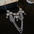Detailed view of silver multi-layer tassel necklace with rhinestones and floral pattern - Silver