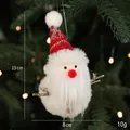Plush Santa Claus ornament with red knit hat hanging on a Christmas tree branch - Plush Santa A