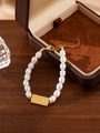 Macro detail of pearl bracelet with golden 11:11 plate and adjustable lobster clasp - 11:11 Angel Number Gold Plate Pearl Beaded Bracelet