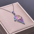 Detailed macro shot of a titanium coated rainbow wolf head pendant with a metal chain - Necklace / Rainbow