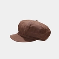 Detail of a brown suede newsboy cap showing stitching and soft texture on a gray background - Brown