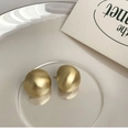 Macro detail of matte brushed gold hemispherical stud earrings on a metal tray - Matte Gold (925 Sterling Silver Pin)