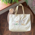 Beigefarbene Canvas-Einkaufstasche mit bunter Lucky Suzakka Bestickung auf Holz - Beige