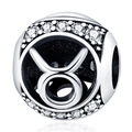 Macro shot of silver Taurus zodiac charm bead with white cubic zirconia inlay - Taurus