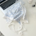 Detailed close-up of a floral cotton linen head scarf with delicate white lace trim - Round Lantern Blue Flower