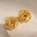 Macro shot of elegant golden metallic rose earrings with textured twisted flower design - Flower Stud Earrings / Gold