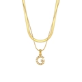 Detailed close-up of double-layer gold snake chain featuring a pearl-inlaid letter G pendant - Letter G