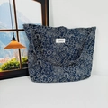 Close-up of navy blue paisley canvas bag with white logo label and durable fabric texture - Navy Ethnic Style