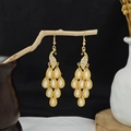 Cloisonne peacock earrings in gold finish with white accents hanging on a dry branch - Gold Peacock Water Drop Pendant