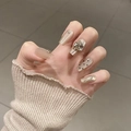 Close-up of handmade press-on nails with luxury butterfly floral design and rhinestones - By1711 Spring Is As Deep As The Sea / Glue Type