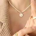 Capricorn zodiac pendant with white freshwater pearl necklace and gold shell charm - Capricorn
