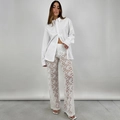 Detail of high-waist white lace sheer wide-leg pants with elegant floral hollow patterns - S / Bottoms / White