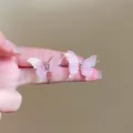 Détail de boucles d'oreilles papillon roses avec finition pailletée et strass brillants - Papillon Rose Dégradé Pailleté (14#)