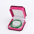 Pink velvet hexagonal jewelry box containing a polished emerald green jade bangle - Bracelet Box / Rose With White Interior