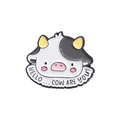 Cartoon cow enamel pin badge with Hello Cow Are You text on a white background - Greeting Cow (HELLO COW ARE YOU)