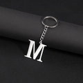 Polished silver metal keychain featuring a capital letter M pendant on a dark background - Letter M
