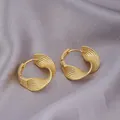 Elegant twisted golden huggie hoop earrings with fish-scale texture on satin - Twisted Embossed Pattern / E-026---Gold