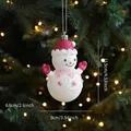 Sparkly white snowman Christmas tree ornament with pink glitter hat and gloves hanging - Snowman