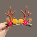 Brown reindeer antler hair clip with pine cone and mushroom detail on a black metal base - Khaki Pine Cone Pom Pom