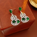 Macro shot of silver gourd earrings featuring green zircon and small white pearls on leather - S925 Silver Pin - Silver - Green
