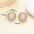 Vintage style oval pink gemstone earrings with zircon halo in golden finish setting - Gold