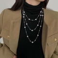 Three-layer black pearl necklace with metal chain and gradient size pearls on a model - Gold Grey Long Pearl Necklace